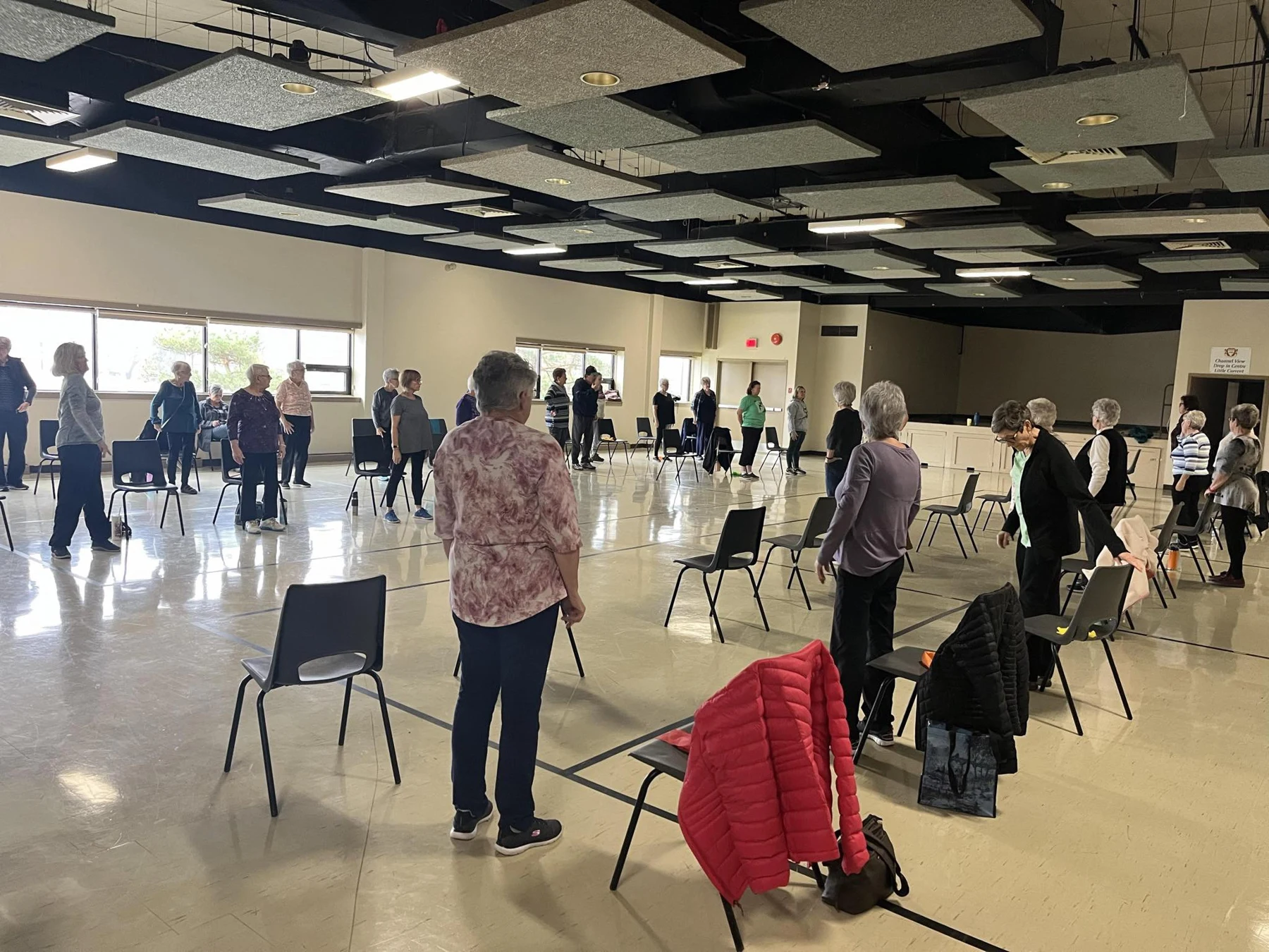 Participants following a standing exercise in a community fitness class